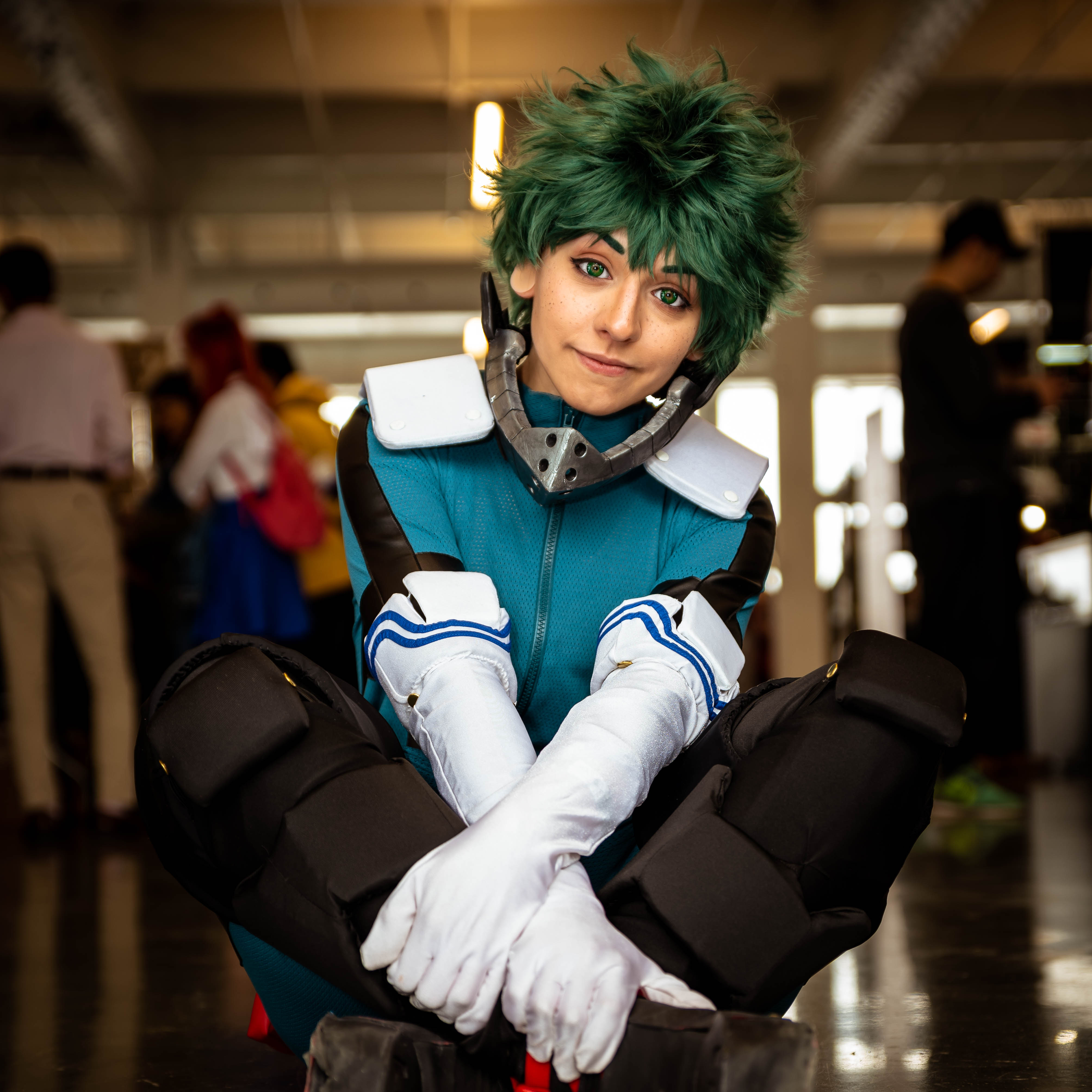 girl in deku cosplay sitting down